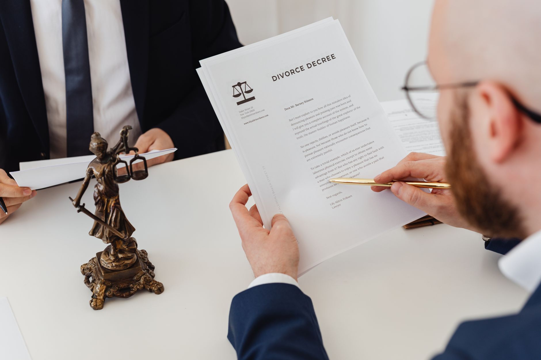 A lawyer signing a document with a pen